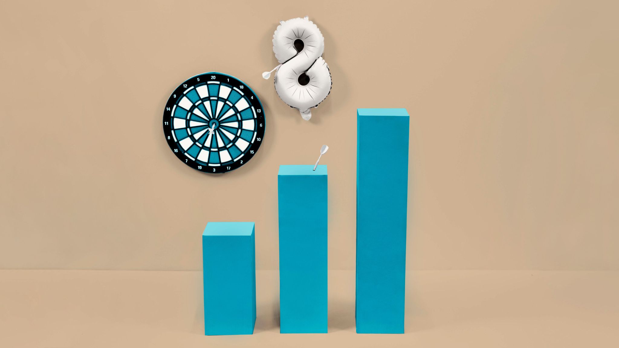 Dartboard and blue growth chart with darts and balloon |Raynet CRM