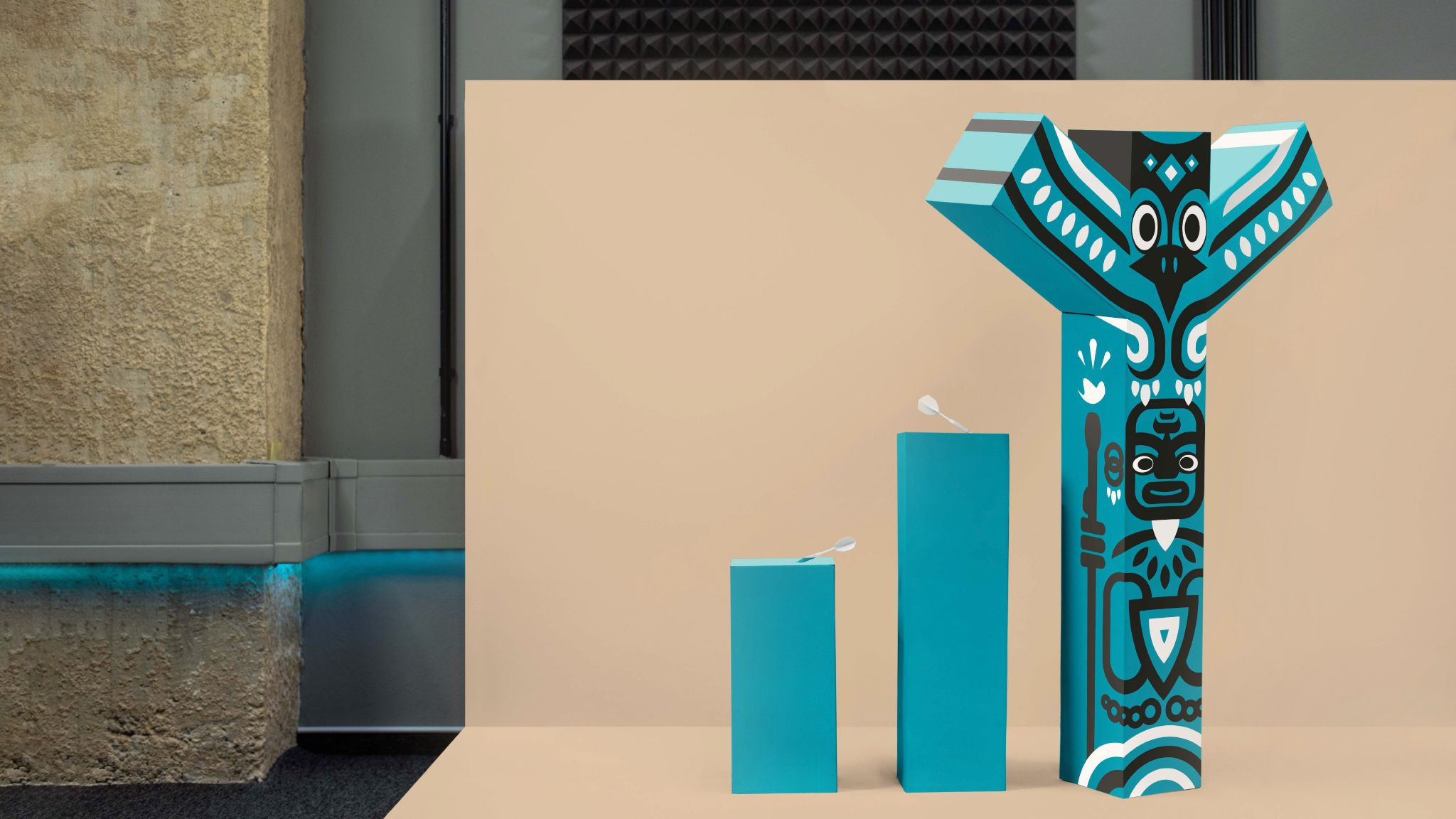 Three_blue_bars_with_darts_the_tallest_decorated_with_a_totem_style_design_Raynet_CRM_0a99a26de4
