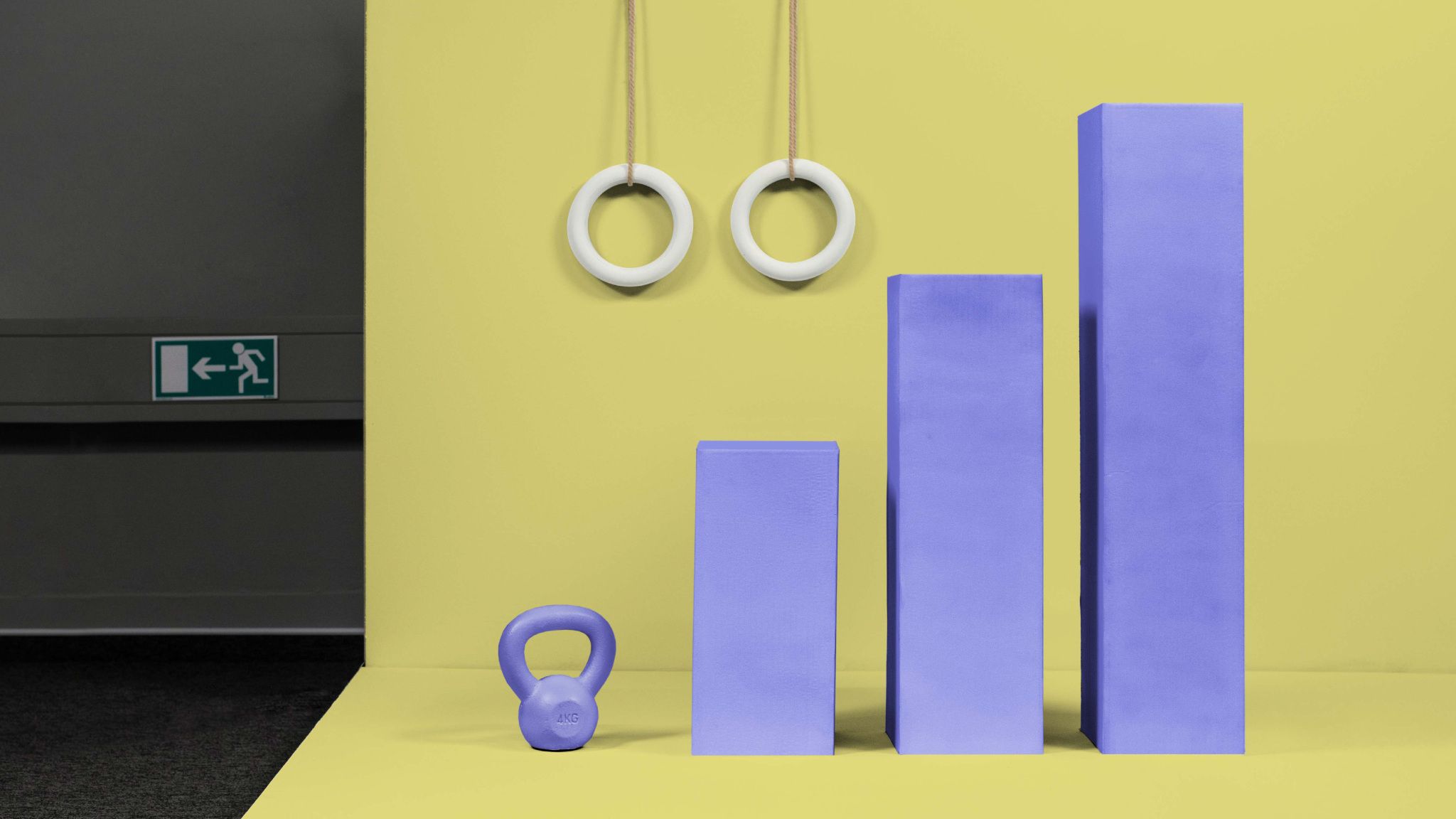 Symbolic business growth represented by purple bars and a kettlebell on a yellow background | Raynet CRM